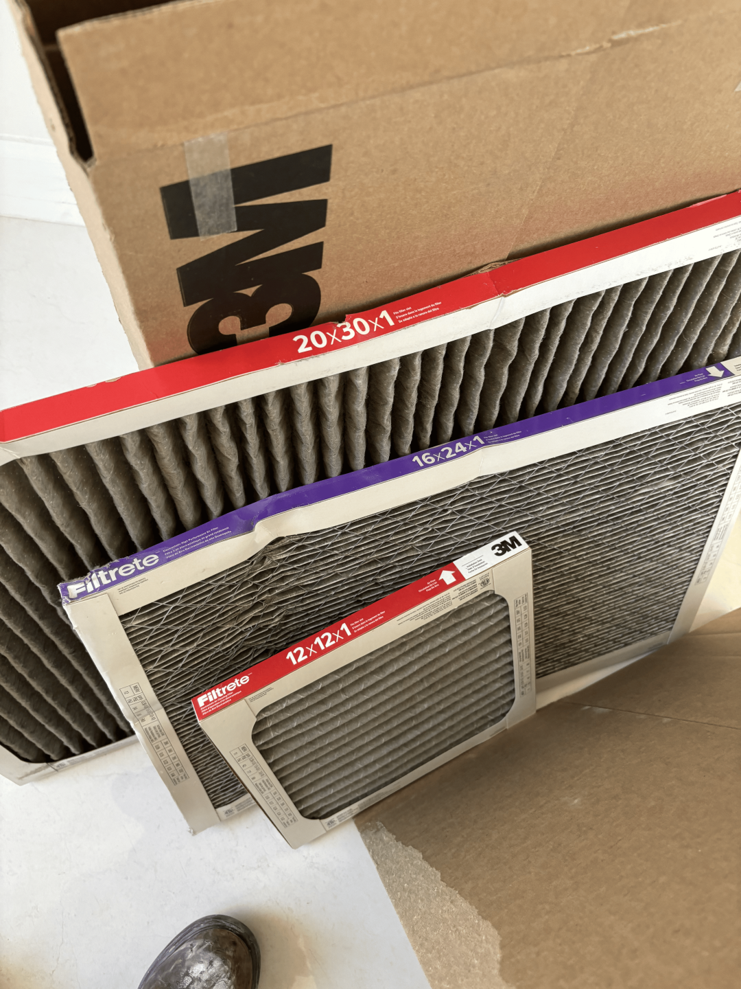 A box with a car air filter placed on top, showcasing automotive maintenance products.