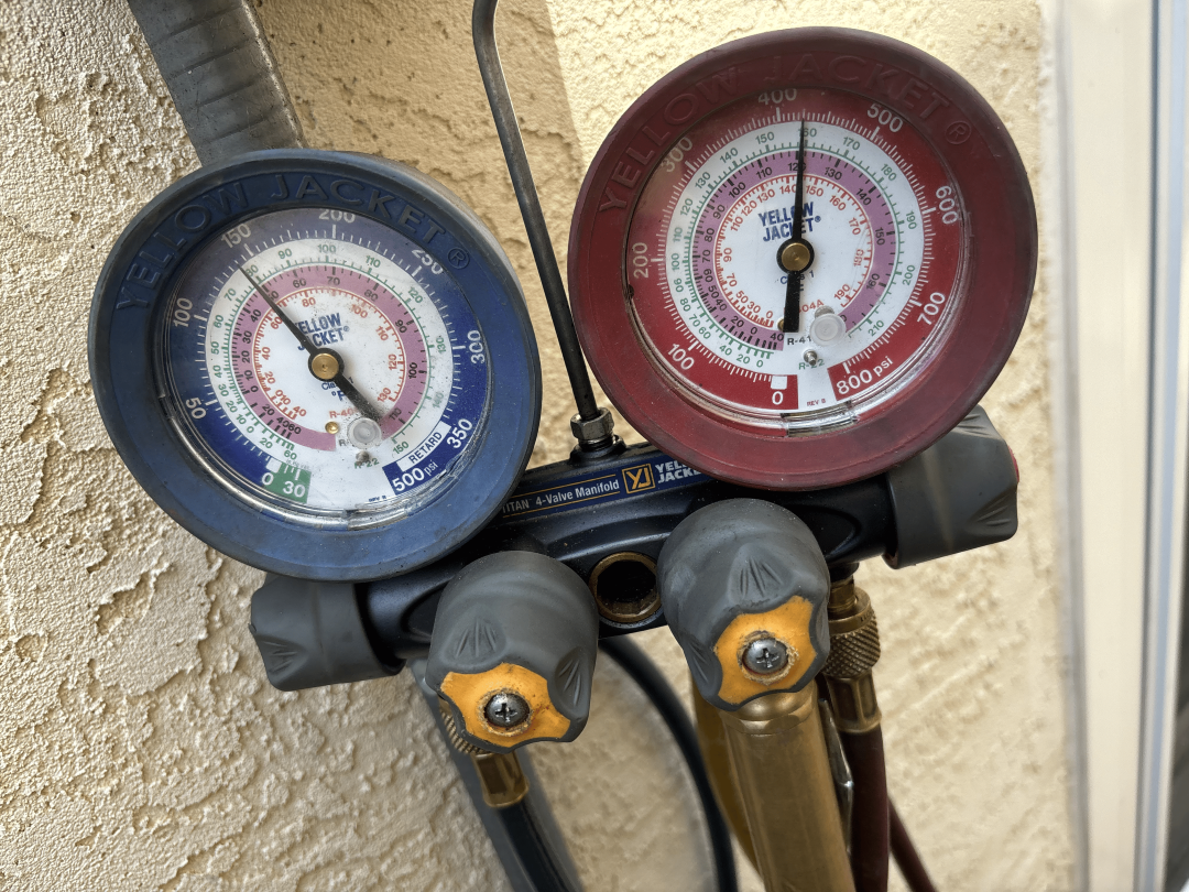 Two pressure gauges mounted on a wall, displaying measurements for monitoring pressure levels in a controlled environment.